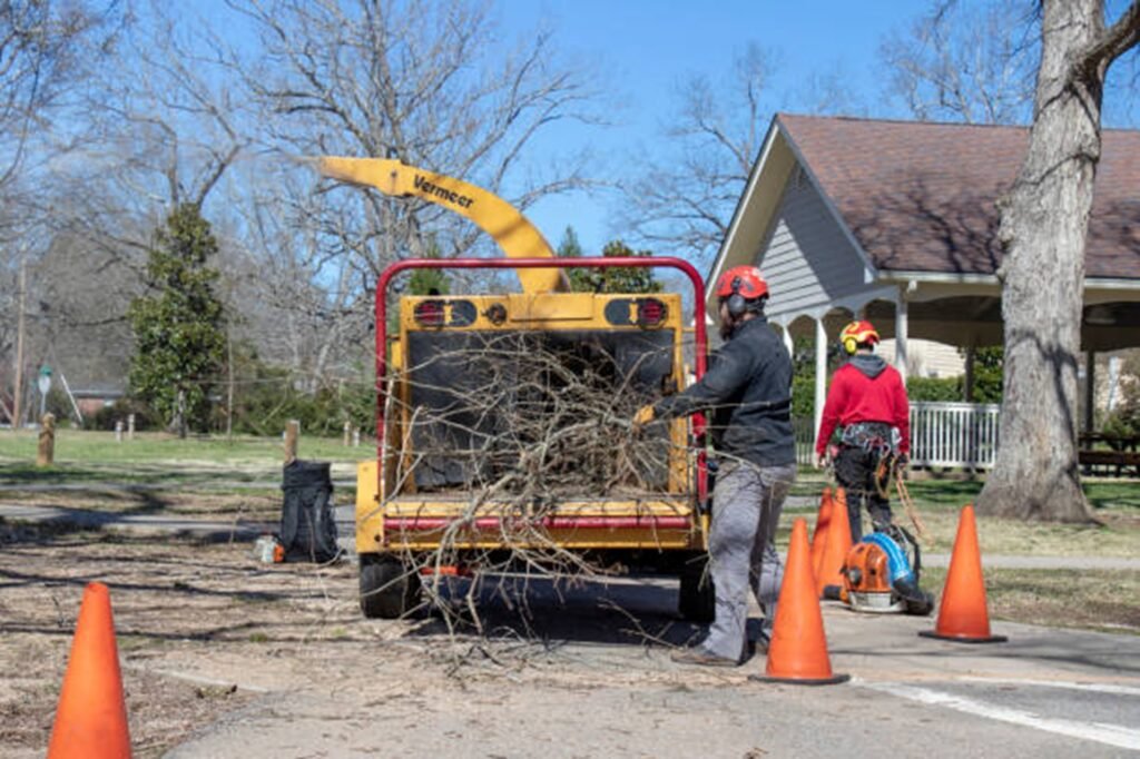 Precision Tree Pros crew loading tree branches into a wood chipper after completing a residential tree service project in Fenton, MO.